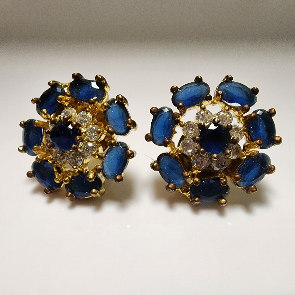 Sapphire blue round floral studs in gold toned metal